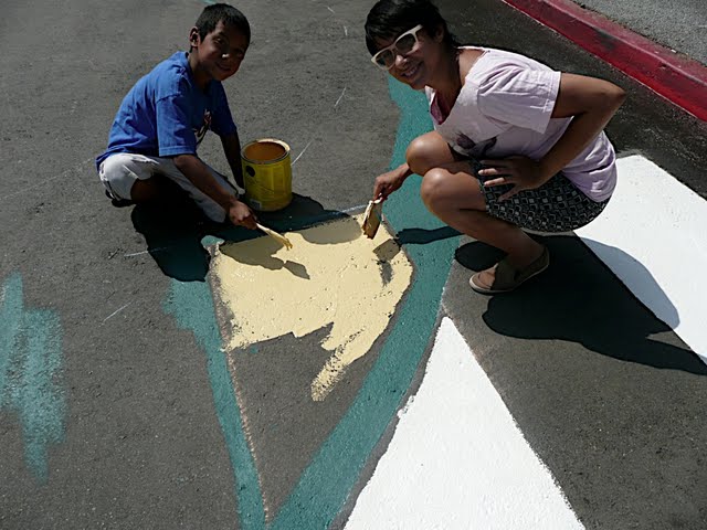 Adonia and a youth whose name I can't remember (sorry) putting down our new crosswalks - photo by Kathy